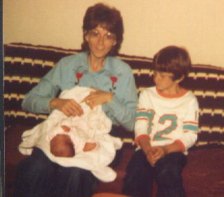 Aunt Karen and Chad holding me when I was a bitty fellow